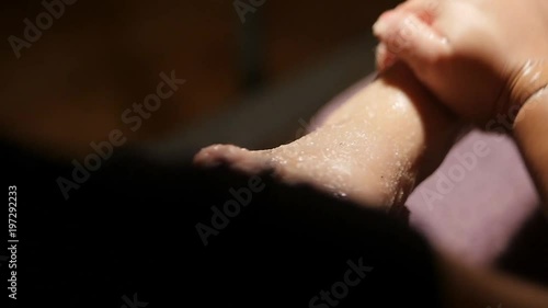 Wallpaper Mural slow motion top down shot of foot receiving salt scrub during pedicure Torontodigital.ca