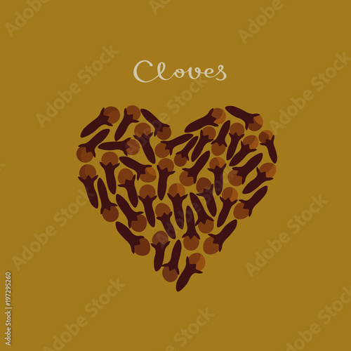 Cloves spice in a heart shape on the yellow background