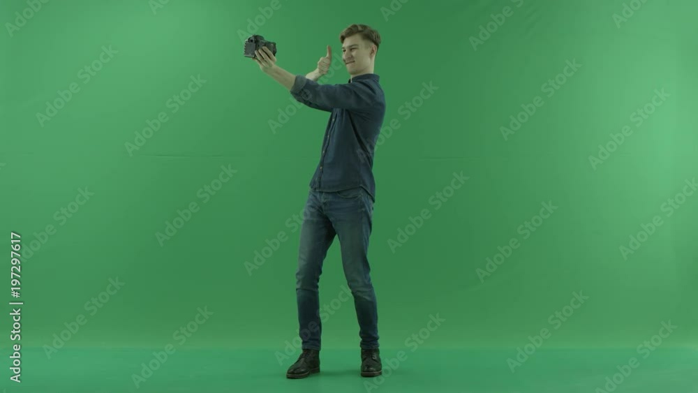 Photographer taking selfies on the green screen Photographer taking selfies on the green screen