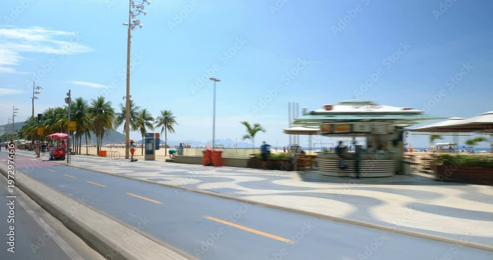 Driving along famous Copacabana Beach walkway with palms in Rio de Janeiro, Brazil Driving along famous Copacabana Beach walkway with palms in Rio de Janeiro, Brazil