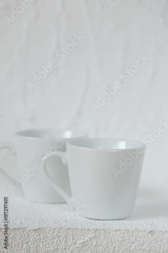 tableware mockup. Minimalist cup Mockup. Two white cups on a white  relief background. White cup . copy space