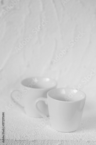 tableware mockup. Minimalist cup Mockup. Two white cups on a white  relief background.  cup on white background. copy space