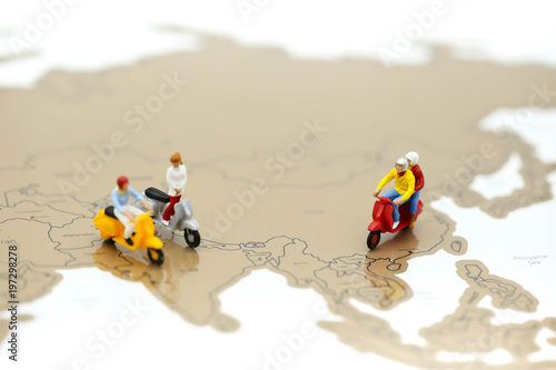 Miniature people : people on scooter with world map,Travel concept.