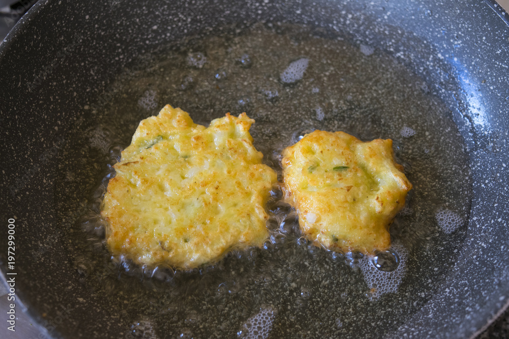 vegetable fritters frying in boiling oil vegetable fritters frying in boiling oil