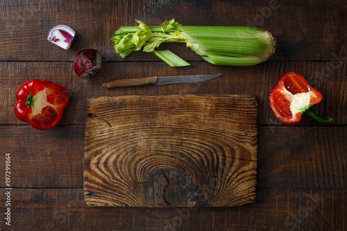 Old wooden cutting board fresh vegetables wooden table top view