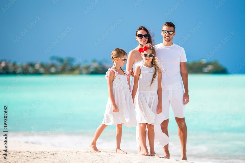Family of four on summer vacation on the beach Family of four on summer vacation on the beach