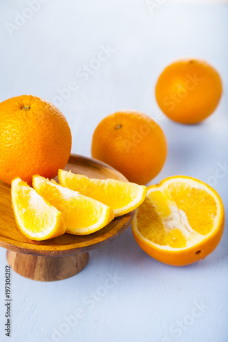 Oranges on a wooden plate