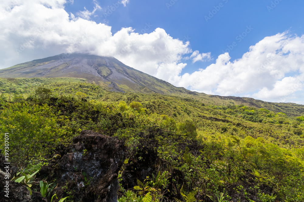 Arenal Volcano in Costa Rica with its peak shrouded in light clouds