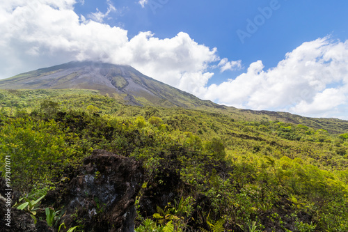 Arenal Volcano in Costa Rica with its peak shrouded in light clouds © josephsjacobs