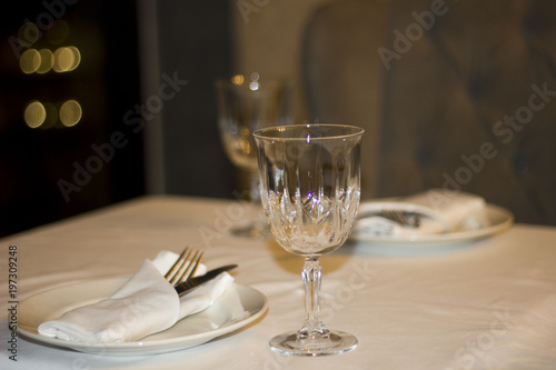 crystal glass and plate devices on the table in the restaurant