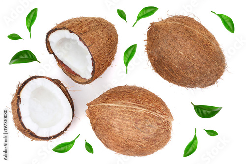 whole coconut with half decorated with leaves isolated on white background. Flat lay. Top view