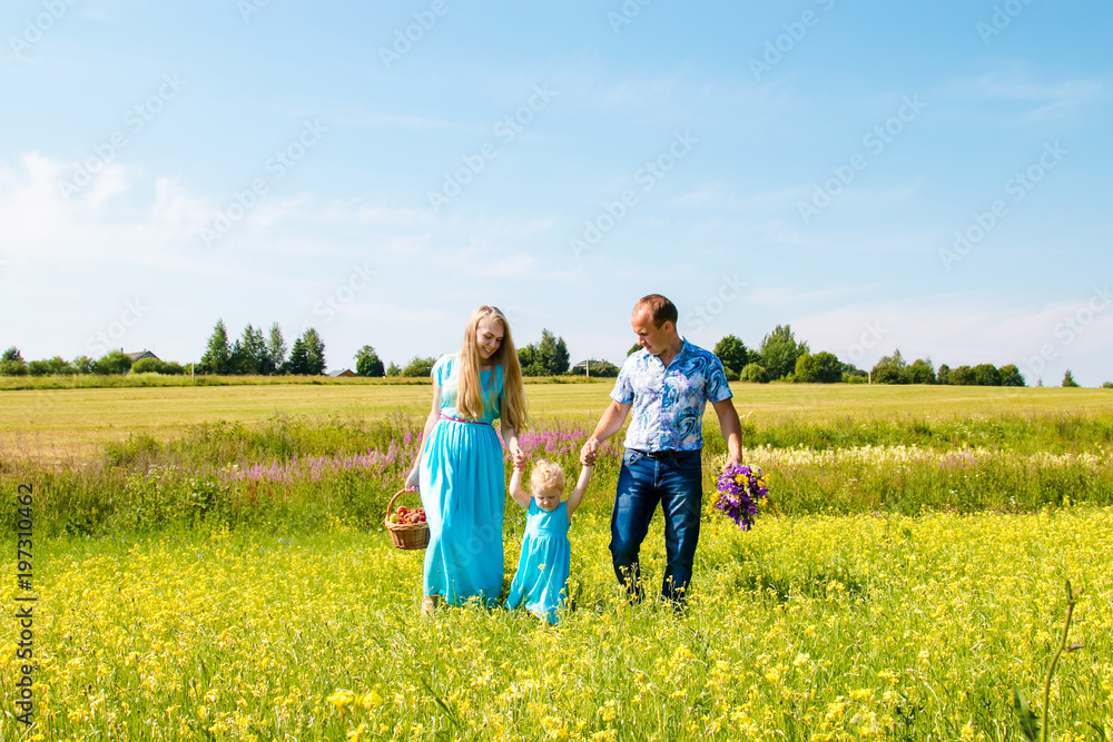 Young happy caucasian family hold baby girl celebration fathers day outdoors. Summer, green field, blue sky Young happy caucasian family hold baby girl celebration fathers day outdoors. Summer, green field, blue sky