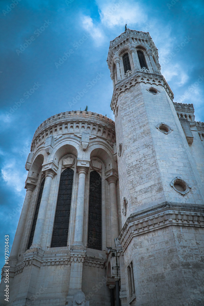 Tower of basilica Notre Dame de Fourvière in Lyon, France with dramatic clouds