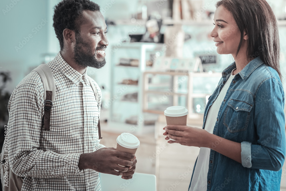 Pleasant communication. Happy positive nice people having coffee and talking to each other while enjoying their communication Pleasant communication. Happy positive nice people having coffee and talking to each other while enjoying their communication