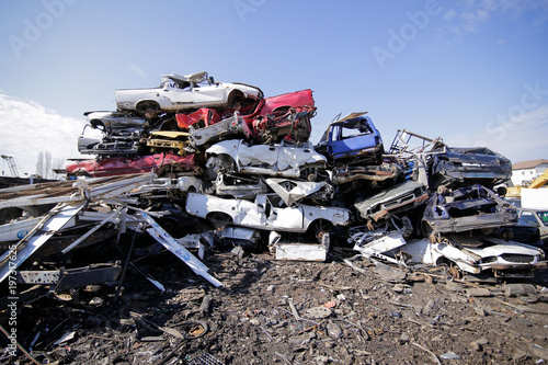 Pile of used old cars at a scrapheap junkyard photo