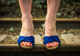 Female legs in blue sandals