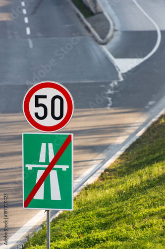 50 km/h speed limit traffic sign and the end of highway sign
