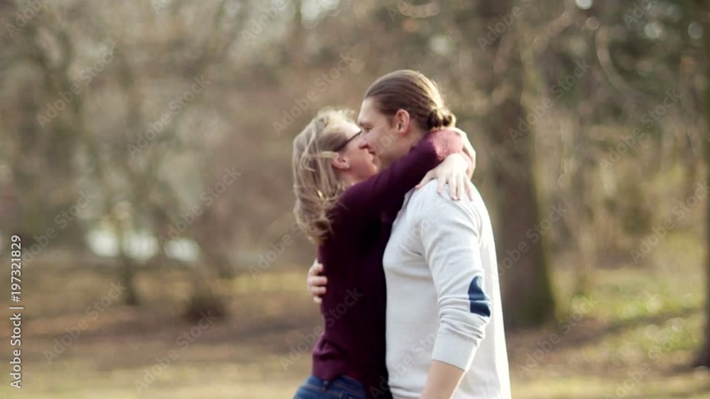 A loving couple hugs and laughs. He inclines the girl and kisses. A passionate kiss. Enthusiastic Friends A loving couple hugs and laughs. He inclines the girl and kisses. A passionate kiss. Enthusiastic Friends