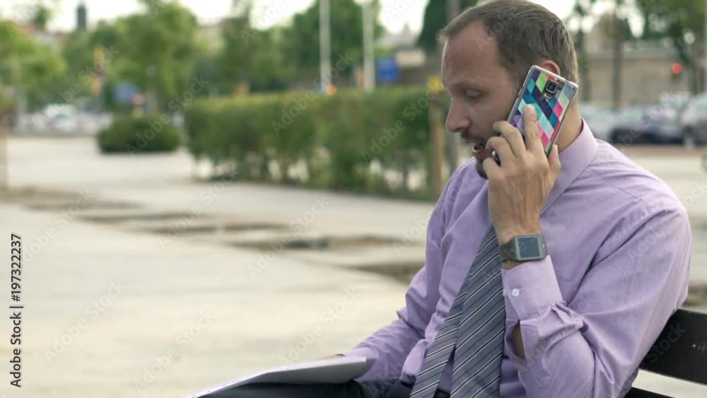 Angry businessman with documents talking on cellphone in city
Angry businessman with documents talking on cellphone in city