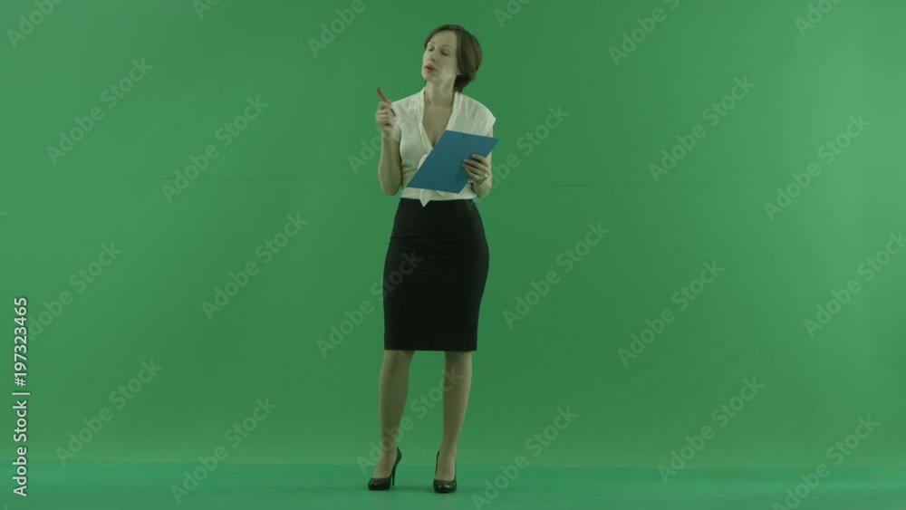 A business woman writes something into her clipboard on the green screen A business woman writes something into her clipboard on the green screen