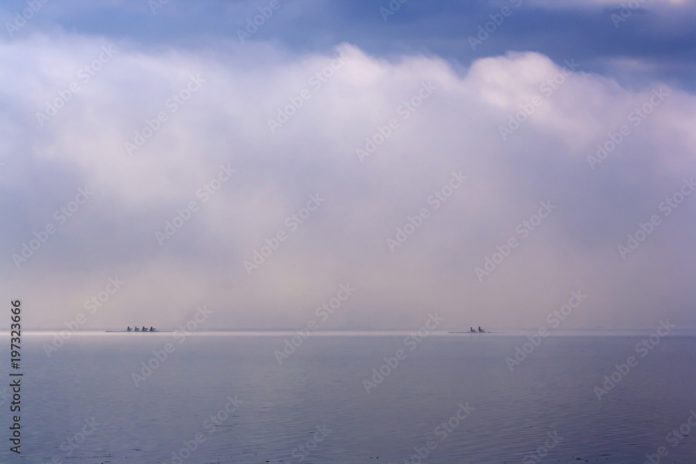 Canoes on the foggy lake