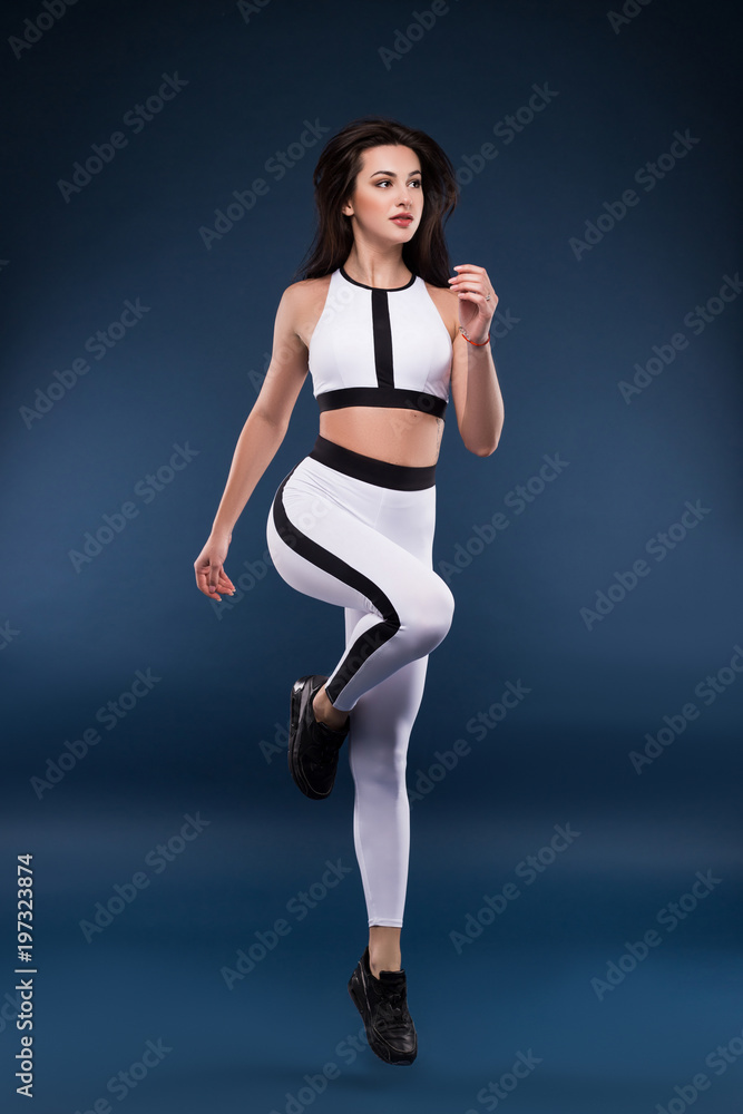 Failure and rejection are only the first step to succeeding. Attractive young fitness model jumping indoors against the isolated background. Failure and rejection are only the first step to succeeding. Attractive young fitness model jumping indoors against the isolated background.