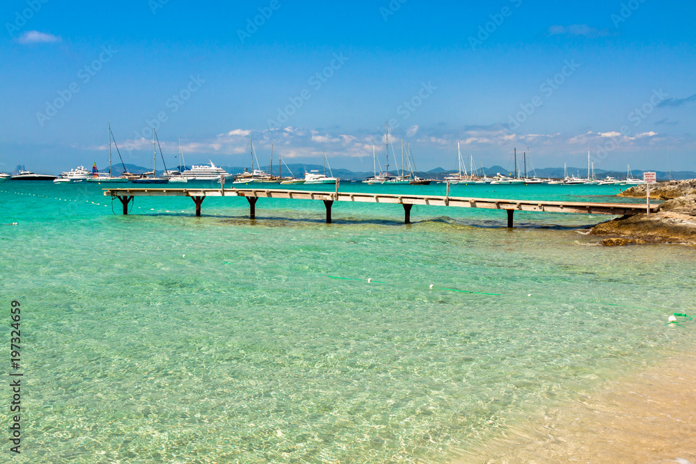 Formentera tropical Mediterranean sea wooden pier in Illetes beach Balearic Islands