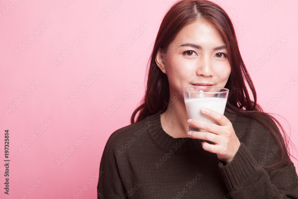 Healthy Asian woman drinking a glass of milk. Healthy Asian woman drinking a glass of milk.