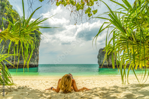Cute woman relaxing on the tropical beach. Vacation at Paradise. Ocean beach relax, travel to islands © Netfalls