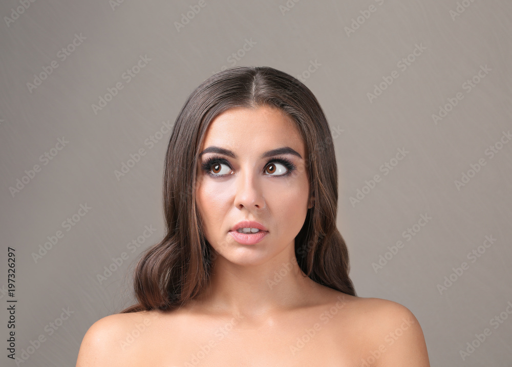 Beautiful young woman with eyelash extensions on color background Beautiful young woman with eyelash extensions on color background