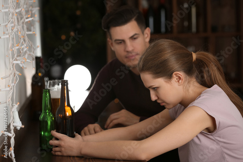 Young couple drinking in bar. Alcoholism problem