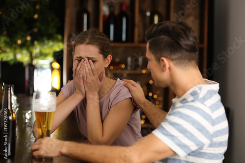 Young couple drinking in bar. Alcoholism problem