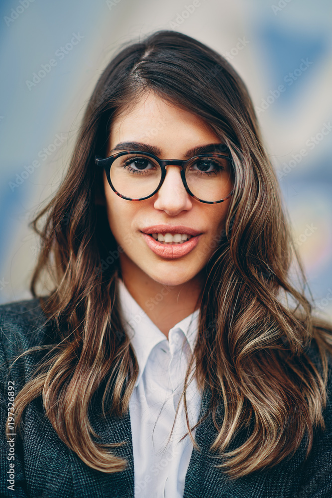 Head shot of beautiful brunette wearing glasses. Head shot of beautiful brunette wearing glasses.