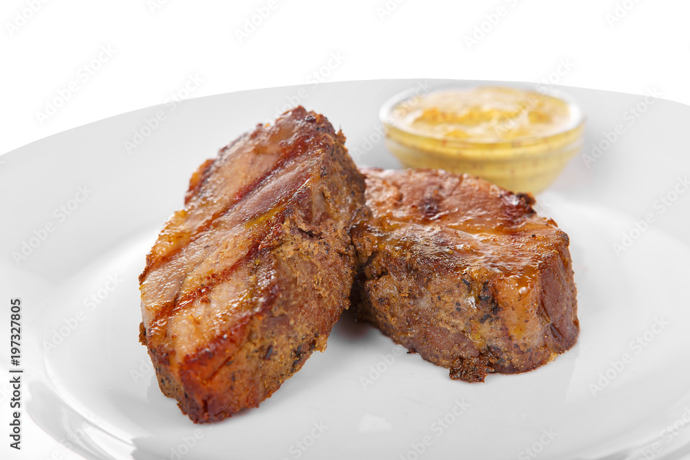 Steak of dark beef, pork, lamb, grilled meat, barbecue, on a plate isolated white background. Mustard, yellow sauce. Juicy fillet, medium, strong roast. For the menu in the restaurant, bar. Side view Steak of dark beef, pork, lamb, grilled meat, barbecue, on a plate isolated white background. Mustard, yellow sauce. Juicy fillet, medium, strong roast. For the menu in the restaurant, bar. Side view