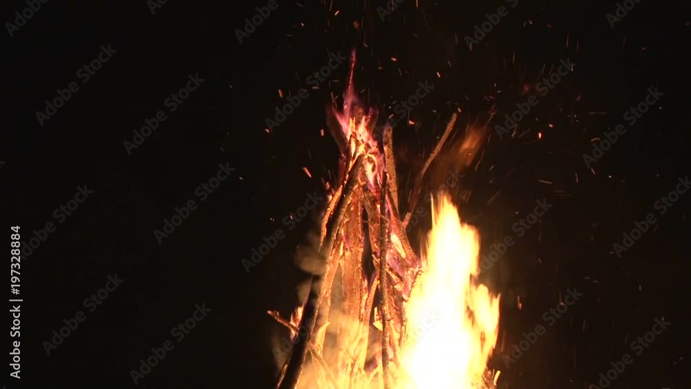 night fire sparks flying in the dark night sky, big night bonfire in a ...
