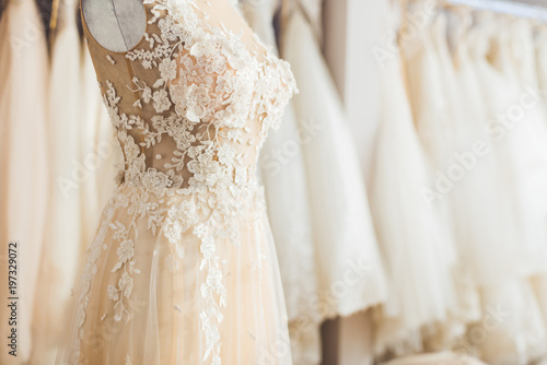 Elegant lace dress on dummy in wedding fashion shop