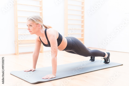 Young attractive smiling woman practicing yoga