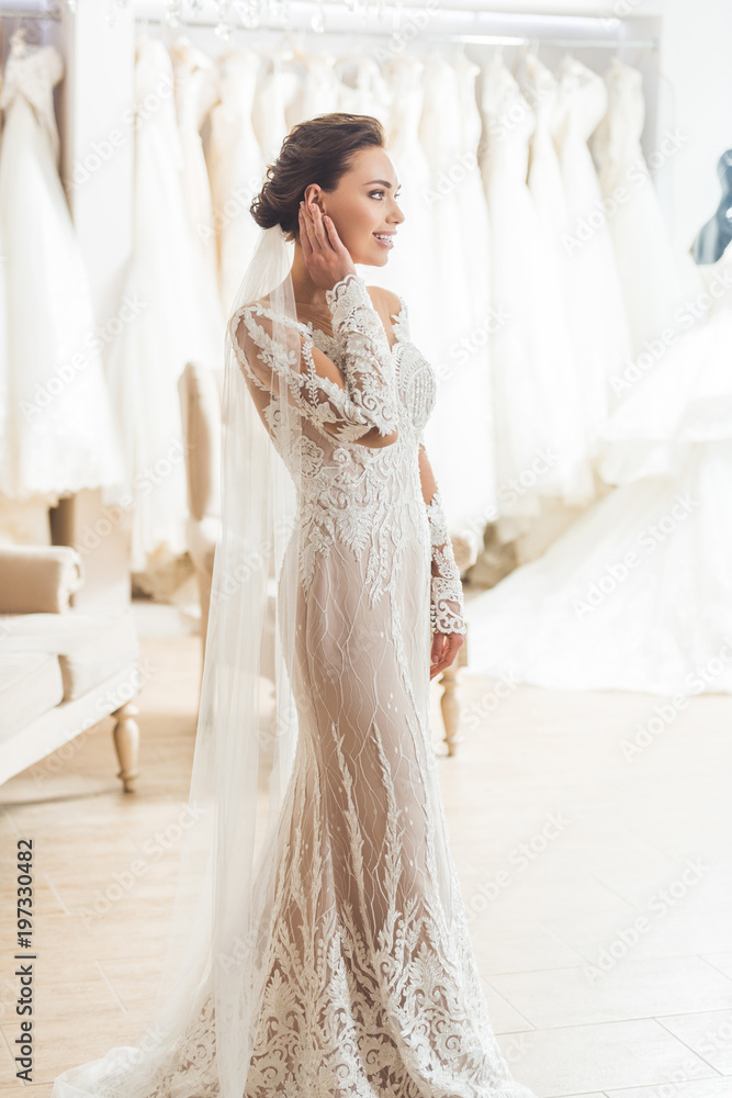 Young bride in white dress in wedding fashion shop