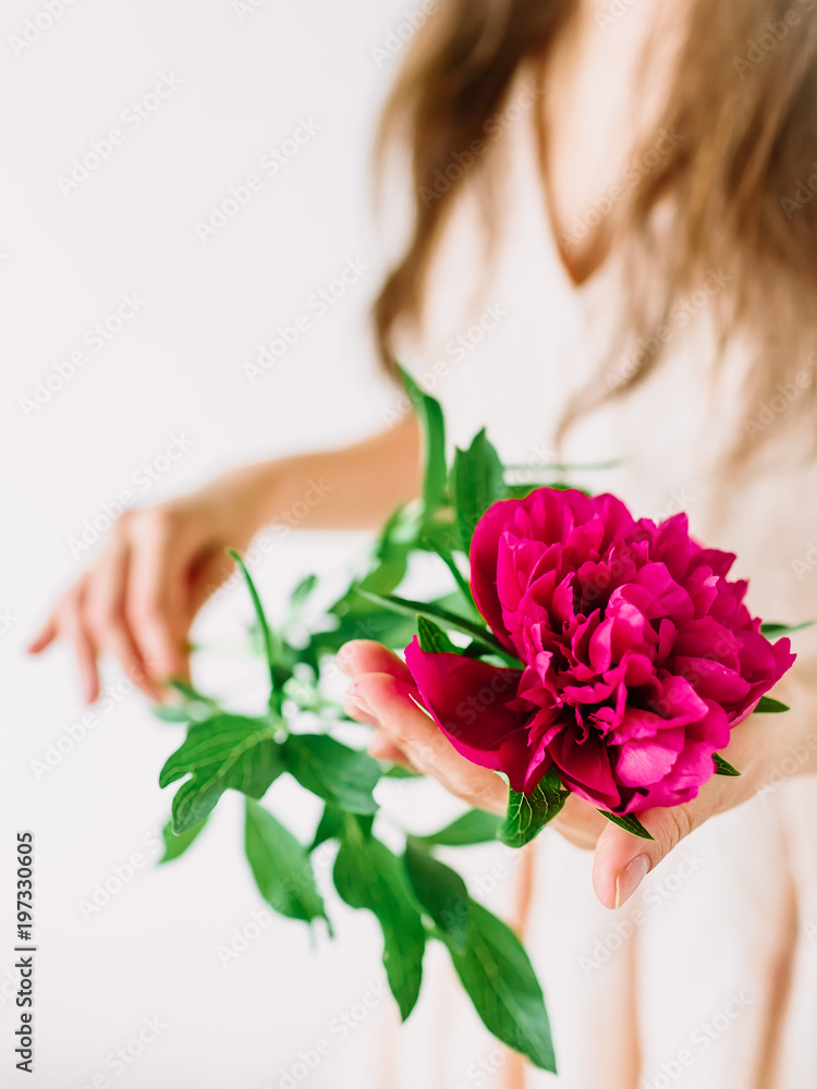 Woman holding bouquet of peonies in hands. Romantic moment