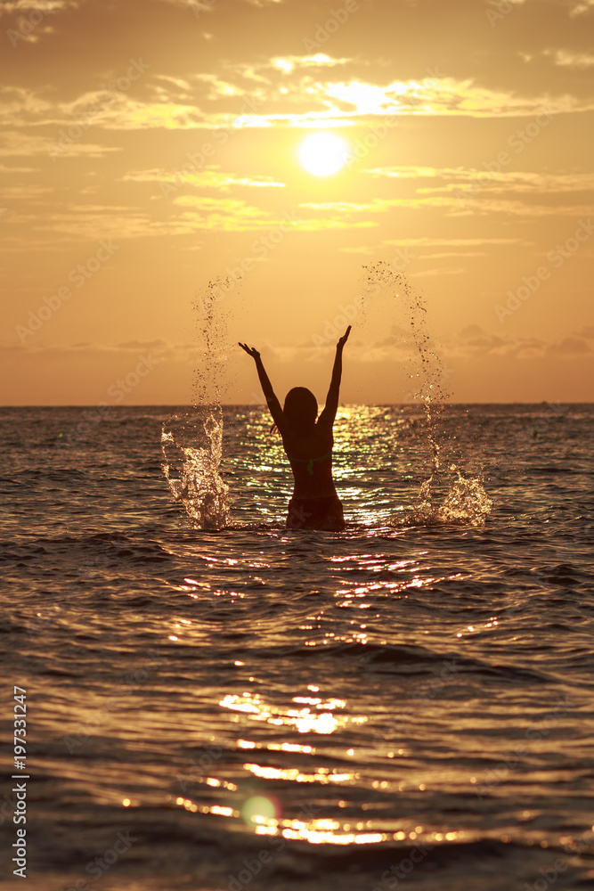 Beautiful Woman in the Sea Waves and Enjoying Sunshine with Open Arms