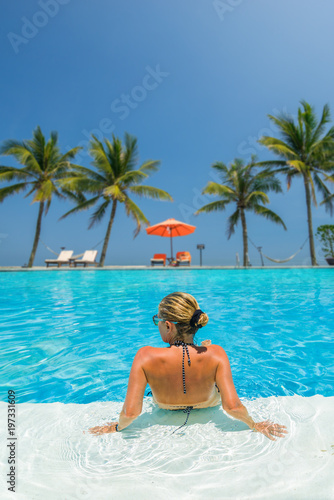 Woman at the swimming pool at the tropical resort © Netfalls