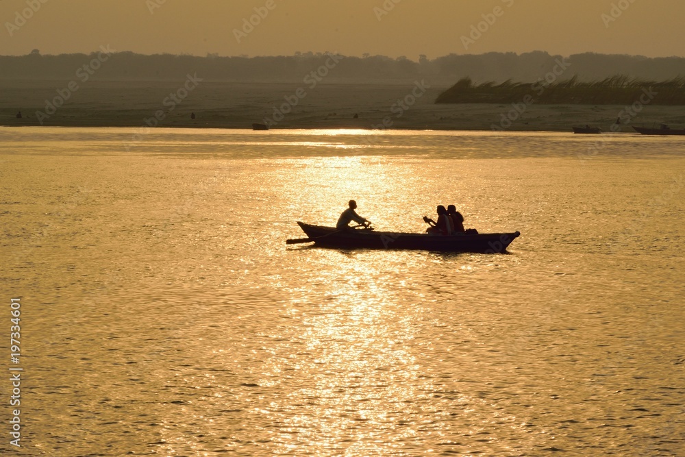 Silhouette tourist boats at Ganges river in Varanasi, India at sunrise. Varanasi is one of the oldest living cities in the world