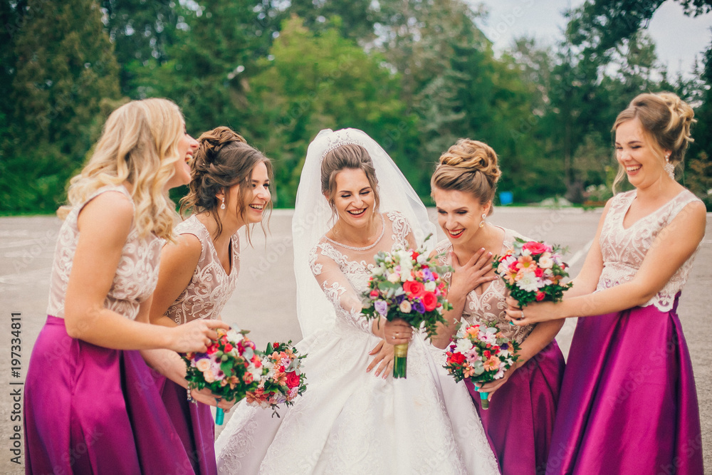 Bride With Bridesmaids On Wedding Day. Bride show bridesmaids her new ring.  The girls laugh. Funny wedding moments. Stock Photo | Adobe Stock