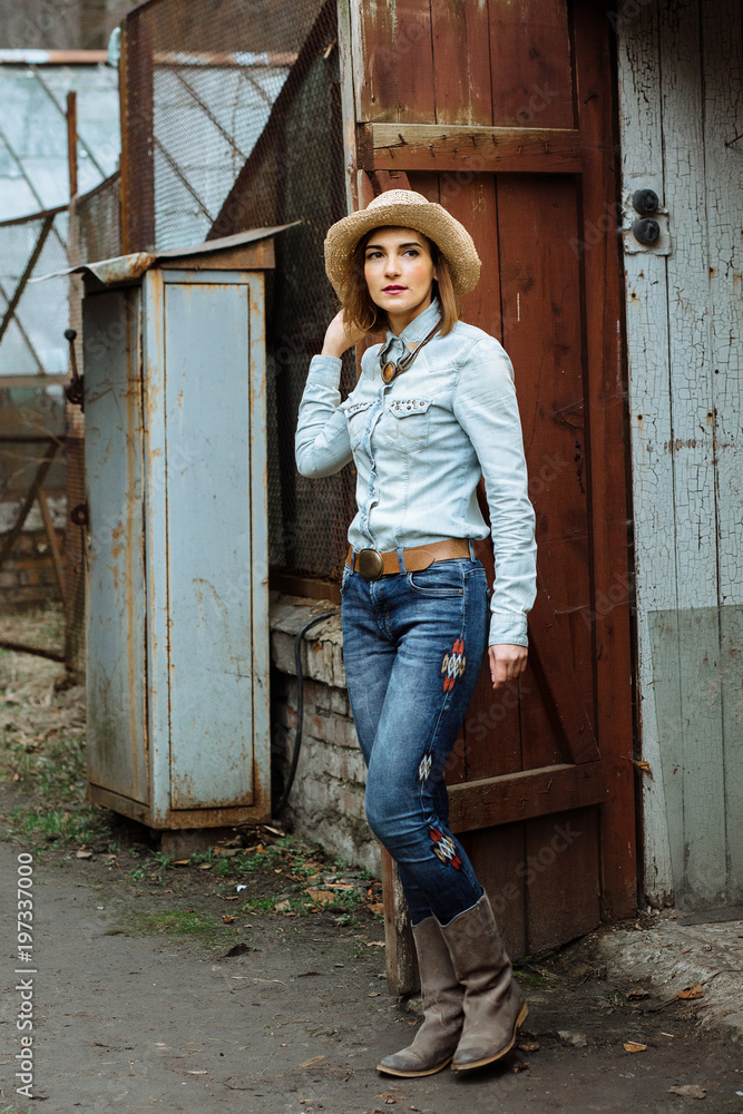 Woman in western wear in cowboy hat, jeans and cowboy boots. Photos | Adobe  Stock