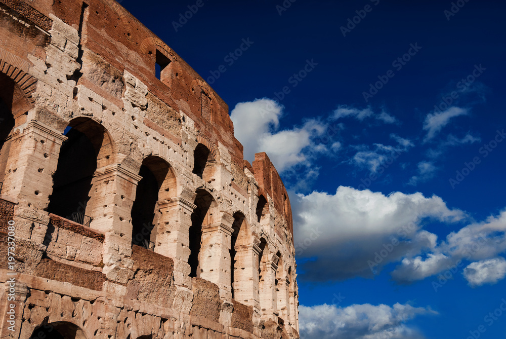 Obraz premium Coliseum inner ring monumental arcades with blue sky and clouds in Rome