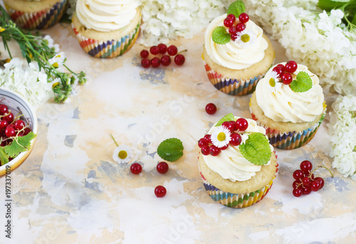 Gentle cupcake with cream and berries on a light background © oksanka8306