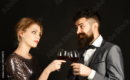Couple in love holding glasses of red wine