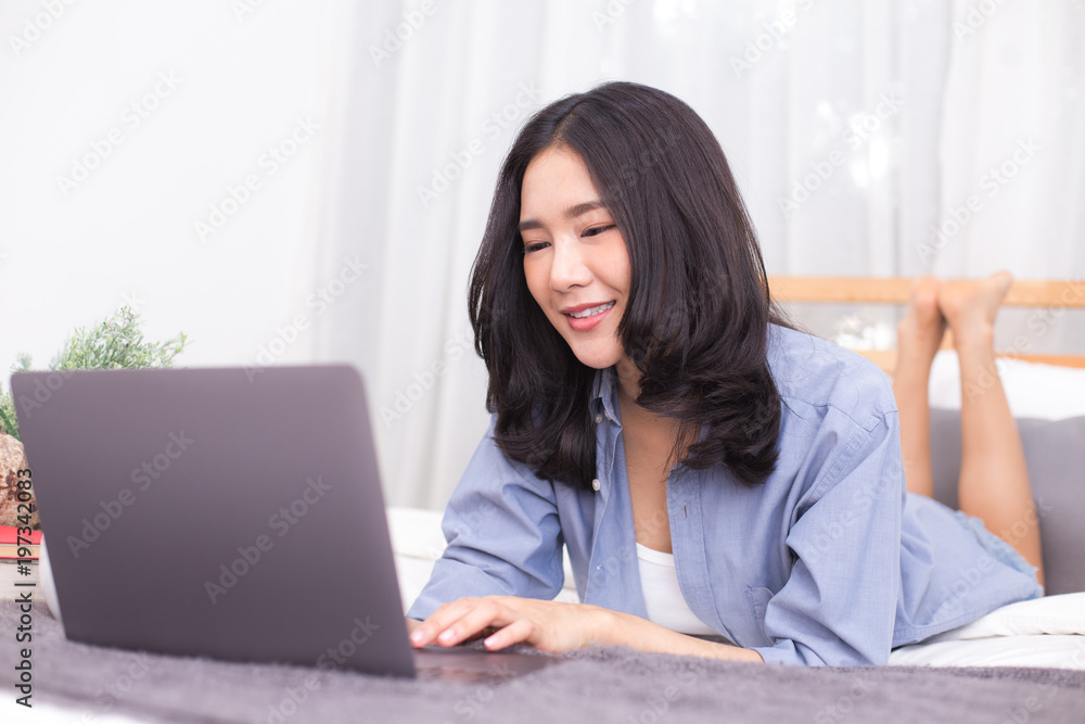 Asian woman using laptop at home. People with technology concept. Asian woman using laptop at home. People with technology concept.