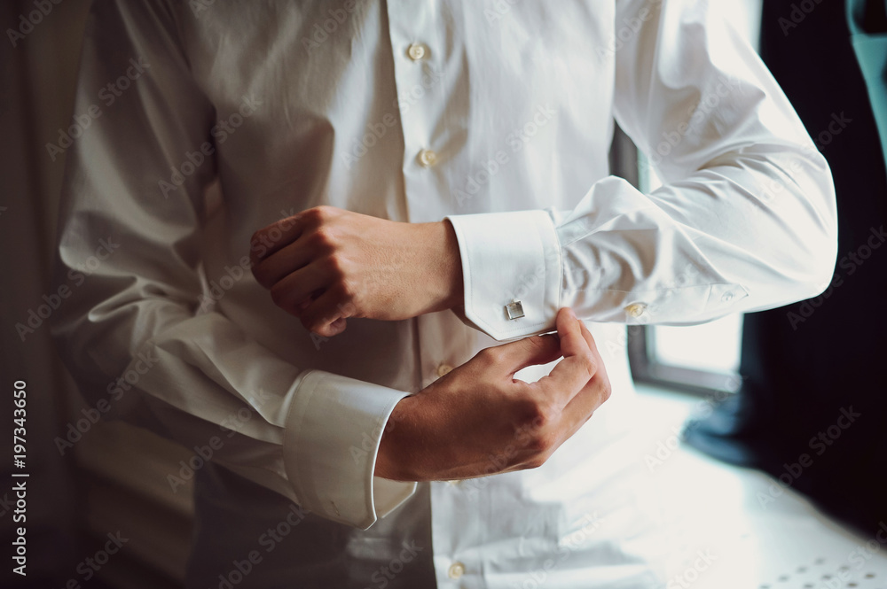 Close up of businessman wearing cufflinks. Elegant young fashion business man wearing suit Close up of businessman wearing cufflinks. Elegant young fashion business man wearing suit