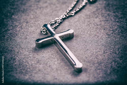 Silver cross on a gray background © merydolla